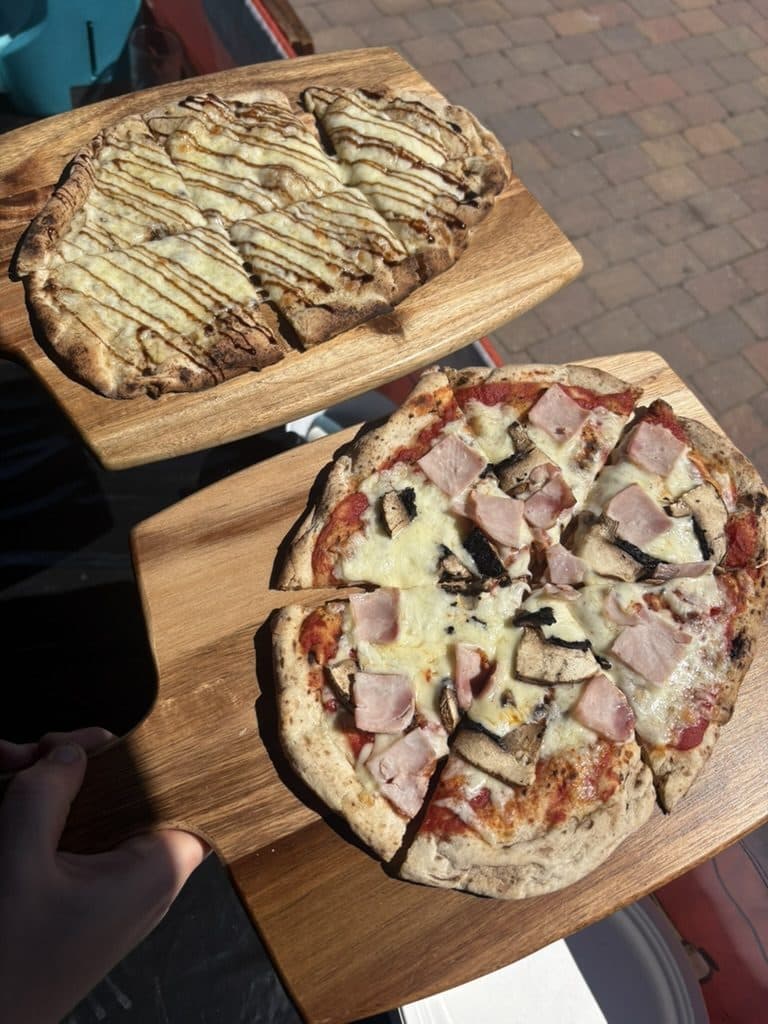 Ham and mushroom pizza with garlic bread at a Gloucestershire event